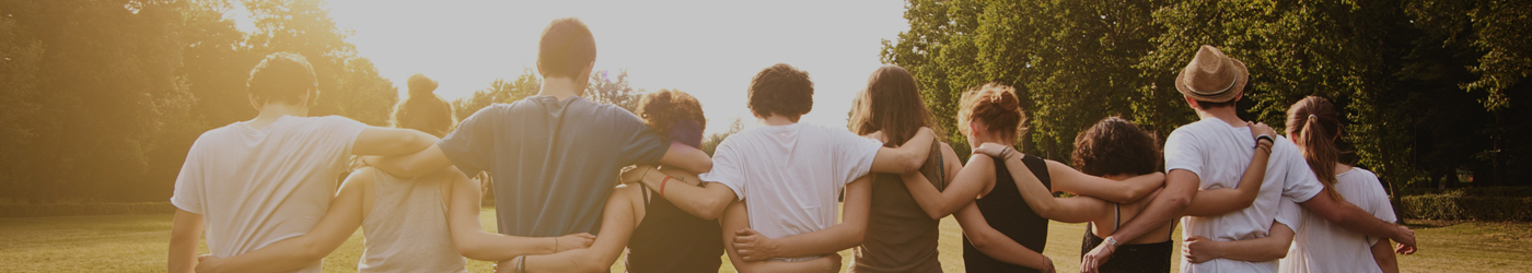 A group of young people with arms interlocked showing their community support